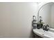 Neutral powder room featuring a black faucet, accent mirror, and a sleek vanity at 1917 Washington St, Durham, NC 27704