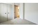 Neutral bedroom with carpet, double closet, and access to hallway and connecting rooms at 1917 Washington St, Durham, NC 27704