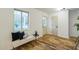 Bright entryway with hardwood floors, a plush bench with decorative pillows, and a view of the front yard at 1917 Washington St, Durham, NC 27704
