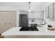 Modern kitchen boasts stainless steel appliances, a gas cooktop, and pristine white cabinetry at 1917 Washington St, Durham, NC 27704