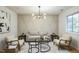 Bright living room featuring modern decor, an accent wall, and neutral-toned furniture at 1917 Washington St, Durham, NC 27704