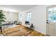 Bright living room with hardwood floors, designer light fixture, and paneled accent wall at 1917 Washington St, Durham, NC 27704