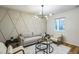 Living room featuring modern decor, an accent wall, neutral-toned furniture, and a large window at 1917 Washington St, Durham, NC 27704