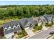 Aerial view of beautiful home with manicured lawn, landscaped garden, and mature trees at 192 Logbridge Rd, Chapel Hill, NC 27516