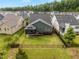 Wide view of fenced backyard featuring a screened porch and healthy green lawn at 192 Logbridge Rd, Chapel Hill, NC 27516