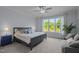 Serene bedroom featuring a plush bed, soft lighting, and a large window offering a picturesque view at 192 Logbridge Rd, Chapel Hill, NC 27516