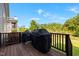 Exterior deck with two grills and wooden railing overlooks lush green lawn at 192 Logbridge Rd, Chapel Hill, NC 27516