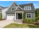 Charming two-story home with a beautiful lawn, inviting front porch, and a convenient attached two-car garage at 192 Logbridge Rd, Chapel Hill, NC 27516