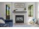 Cozy fireplace with decorative mantle, next to screened porch access, and a view of the backyard at 192 Logbridge Rd, Chapel Hill, NC 27516