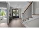 Bright foyer with hardwood floors, staircase with iron spindles, and elegant decor, creating a welcoming entry at 192 Logbridge Rd, Chapel Hill, NC 27516