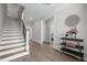 Bright foyer with hardwood floors, staircase with iron spindles, and elegant decor, creating a welcoming entry at 192 Logbridge Rd, Chapel Hill, NC 27516