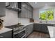 Contemporary kitchen with stainless steel appliances, gray cabinets, and bright white countertop at 192 Logbridge Rd, Chapel Hill, NC 27516