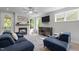 Comfortable seating arrangement in a sunlit living room with a stylish fireplace and modern television at 192 Logbridge Rd, Chapel Hill, NC 27516