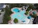 An aerial view of a community pool area featuring multiple pools, a water slide, and lounge chairs at 192 Logbridge Rd, Chapel Hill, NC 27516