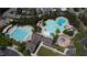 Aerial view of a community pool area with multiple pools, waterslides, lounge chairs, and playground at 192 Logbridge Rd, Chapel Hill, NC 27516