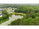 Scenic community houses nestled by a tranquil pond bordered by verdant forest landscape at 1969 Bowles Ave, Creedmoor, NC 27522