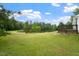 Expansive backyard with a pond, trees, and well-manicured lawn at 1969 Bowles Ave, Creedmoor, NC 27522