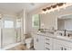This bathroom features double sinks, granite countertops, and a glass shower at 1969 Bowles Ave, Creedmoor, NC 27522