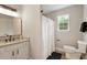 Bright bathroom featuring granite countertop vanity, and a shower with natural light at 1969 Bowles Ave, Creedmoor, NC 27522