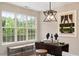 Inviting dining area with a window view, stylish pendant lighting and unique artwork at 1969 Bowles Ave, Creedmoor, NC 27522