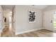 Spacious entryway with wood floors and a modern art piece, leading to other rooms at 1969 Bowles Ave, Creedmoor, NC 27522