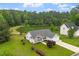 Beautiful home with well-maintained lawn backing onto a serene pond and lush greenery at 1969 Bowles Ave, Creedmoor, NC 27522