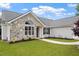 Attractive front of house with stone details and landscaped garden at 1969 Bowles Ave, Creedmoor, NC 27522