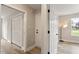 Hallway with several white doors and a view into a room with a standing lamp at 1969 Bowles Ave, Creedmoor, NC 27522