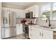 Bright kitchen boasts stainless steel appliances, white cabinetry, and a window over the sink at 1969 Bowles Ave, Creedmoor, NC 27522