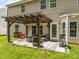 Inviting backyard patio featuring a pergola, lounge furniture, swing, grill, and well-maintained lawn at 2012 Sterling Hill Dr, Fuquay Varina, NC 27526