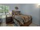Comfortable bedroom with a queen-sized bed, accent rug, and ample natural light at 2012 Sterling Hill Dr, Fuquay Varina, NC 27526