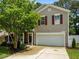 Charming two-story home features a manicured lawn, a two-car garage, and lovely curb appeal at 2012 Sterling Hill Dr, Fuquay Varina, NC 27526