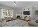 Bright and inviting living room features a cozy fireplace and plenty of natural light at 2012 Sterling Hill Dr, Fuquay Varina, NC 27526