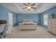 Generously sized main bedroom features two windows, blue accent wall, and a tray ceiling at 2012 Sterling Hill Dr, Fuquay Varina, NC 27526