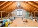 Spacious unfinished attic with exposed wooden beams, offering potential for storage or conversion into a functional living area at 203 Lighthouse Way, Cary, NC 27511