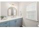 Stylish powder room features a light blue vanity and a decorative gold mirror at 203 Lighthouse Way, Cary, NC 27511