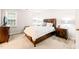 This primary bedroom features a plush carpet, bedside lamps and multiple windows at 203 Lighthouse Way, Cary, NC 27511