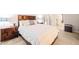 This primary bedroom boasts a plush carpet, bedside lamps and is furnished with a queen bed at 203 Lighthouse Way, Cary, NC 27511