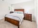 Spacious bedroom with dark wood furniture and neutral bedding at 203 Lighthouse Way, Cary, NC 27511