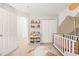 Bedroom with decor shelving, crib, patterned rug, and closet at 203 Lighthouse Way, Cary, NC 27511