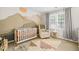Modern Bedroom with mountain mural, patterned rug, and comfortable seating at 203 Lighthouse Way, Cary, NC 27511