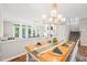 Dining room boasts wooden table with seating for eight, and open access to living area at 203 Lighthouse Way, Cary, NC 27511