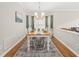 A dining room with light wood flooring, a chandelier, large rug and seating for eight at 203 Lighthouse Way, Cary, NC 27511