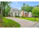 Lovely home with long driveway, manicured lawn, mature trees, and traditional architecture creating an inviting curb appeal at 203 Lighthouse Way, Cary, NC 27511