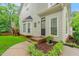 Charming home featuring a well-manicured front yard, complimented by a bay window and decorative plantings at 203 Lighthouse Way, Cary, NC 27511