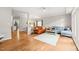 Open concept living area with hardwood floors, comfortable sofas, and adjoining dining room at 203 Lighthouse Way, Cary, NC 27511