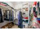 Organized walk-in closet with shelves, hanging space, and shoe storage, providing ample space for clothes and accessories at 203 Lighthouse Way, Cary, NC 27511