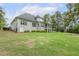 Exterior of a grey home with a big backyard, screened-in porch, and patio seating at 205 Sherman Pines Dr, Fuquay Varina, NC 27526