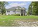 Grey home exterior with large backyard, screened-in porch, and patio seating at 205 Sherman Pines Dr, Fuquay Varina, NC 27526