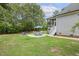 Backyard with outdoor seating area, fire pit, and lush greenery at 205 Sherman Pines Dr, Fuquay Varina, NC 27526